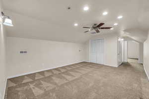Bonus room featuring vaulted ceiling, carpet, a ceiling fan, baseboards, and recessed lighting