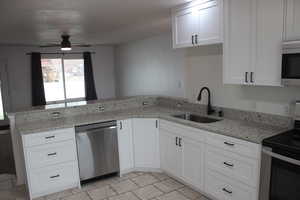 Kitchen with white cabinetry, a sink, ceiling fan, a peninsula, and appliances with stainless steel finishes