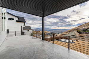 View of patio featuring a balcony and a mountain view