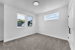 Unfurnished room featuring baseboards and carpet floors