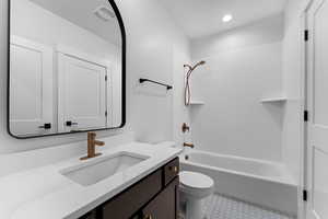 Full bath featuring vanity, recessed lighting, toilet, bathing tub / shower combination, and tile patterned floors