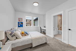 Bedroom with carpet flooring, connected bathroom, baseboards, and visible vents