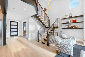 Foyer entrance with baseboards, light wood finished floors, and recessed lighting