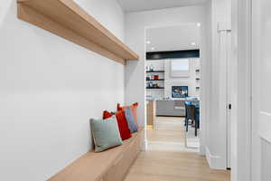 Mudroom featuring a glass covered fireplace, light wood finished floors, and recessed lighting