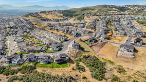 Aerial overview of property's location featuring nearby suburban area and mountains