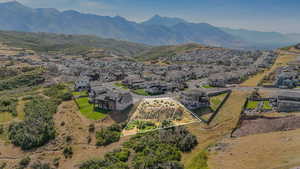 Aerial perspective of suburban area featuring property parcel outlined and a mountain backdrop
