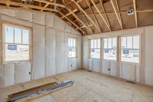Primary bedroom with vaulted ceiling