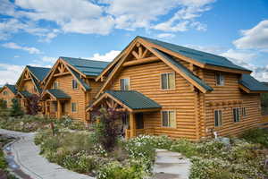 Log-style house with log siding and metal roof