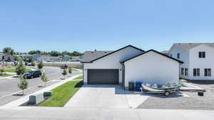 View of home's exterior with a garage, driveway, and a residential view