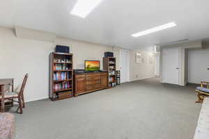 Interior space with baseboards and light colored carpet