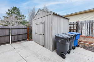 View of shed with a fenced backyard