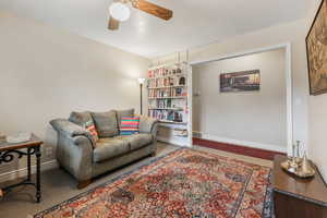 Living area with baseboards, ceiling fan, and visible vents