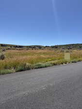 View of asphalt street featuring a view of countryside