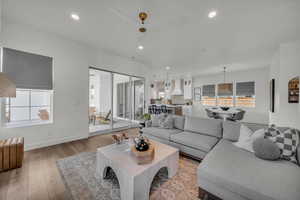 Living area with recessed lighting, plenty of natural light, and light wood-style flooring