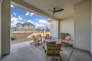 View of patio / terrace featuring a residential view, a ceiling fan, and fence