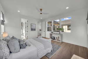 Bedroom with recessed lighting, wood finished floors, a ceiling fan, and baseboards