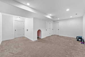 Below grade area featuring baseboards, visible vents, recessed lighting, and carpet