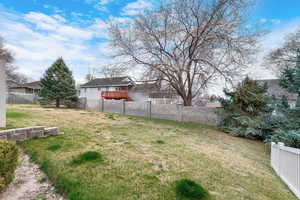 View of yard featuring a fenced backyard and a deck