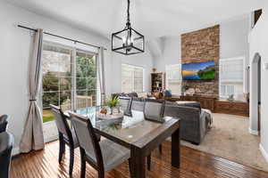Dining room featuring baseboards, a notable chandelier, visible vents, and wood finished floors