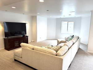 Living room with baseboards, carpet floors, recessed lighting, and crown molding