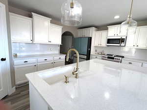 Kitchen with new microwave, range, a sink, and smart refrigerator