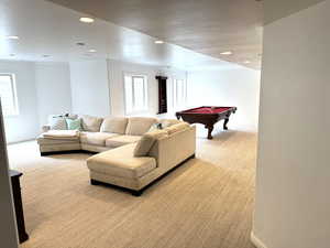 Carpeted living area featuring baseboards, recessed lighting, and billiard set