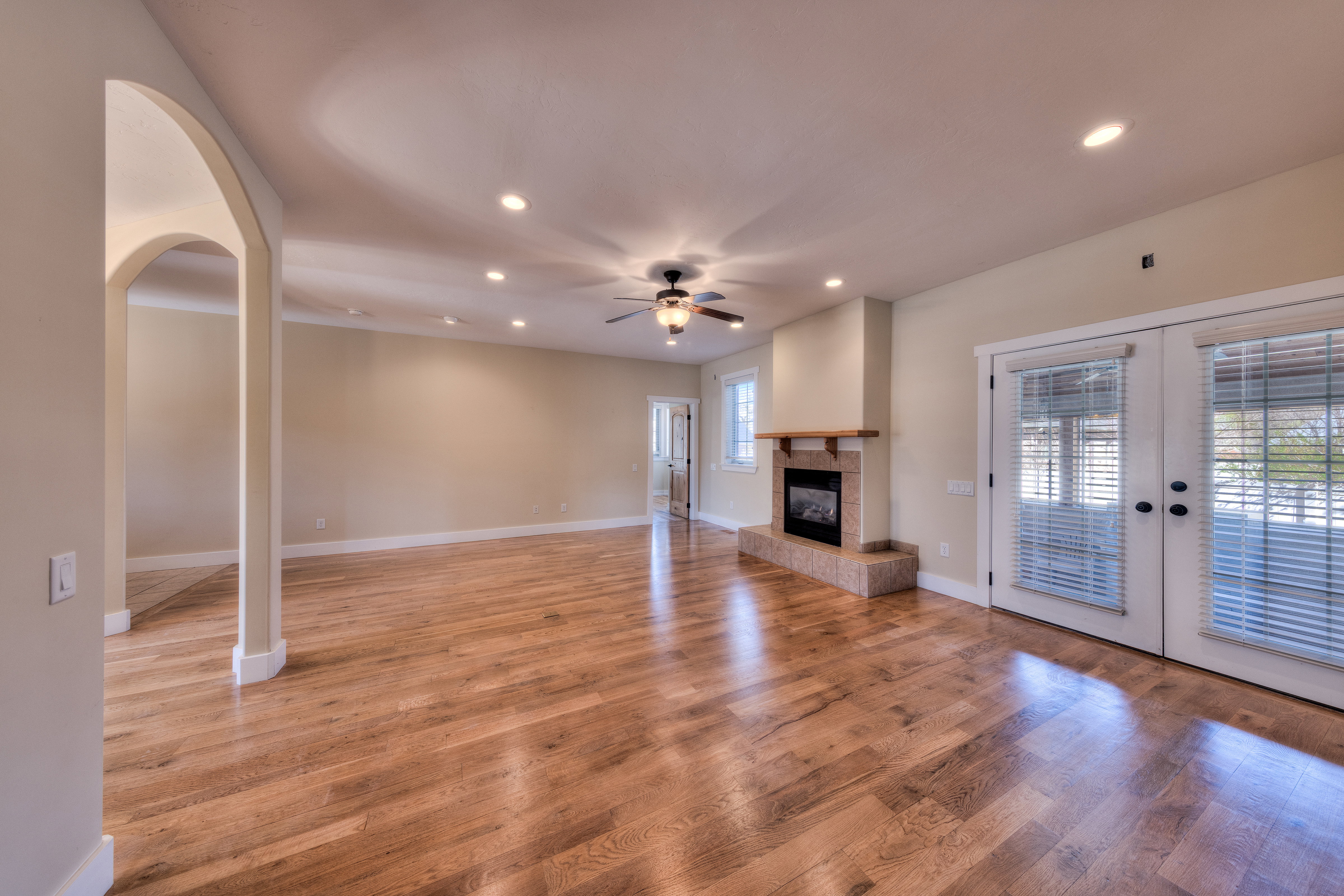 Unfurnished living room with ceiling fan, recessed lighting, french doors, and light wood-style floors