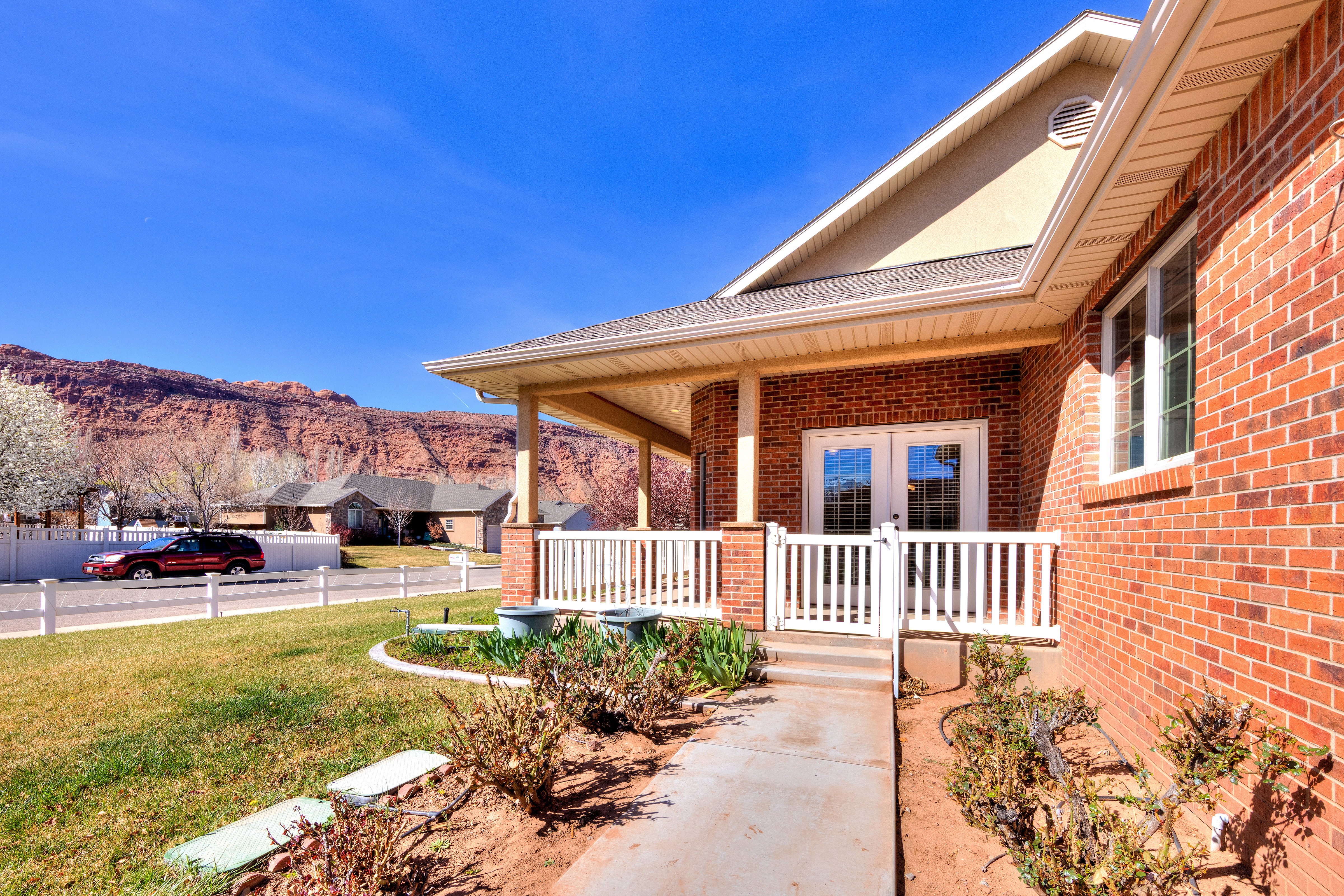 View of patio with french doors, a porch, and a mountain view