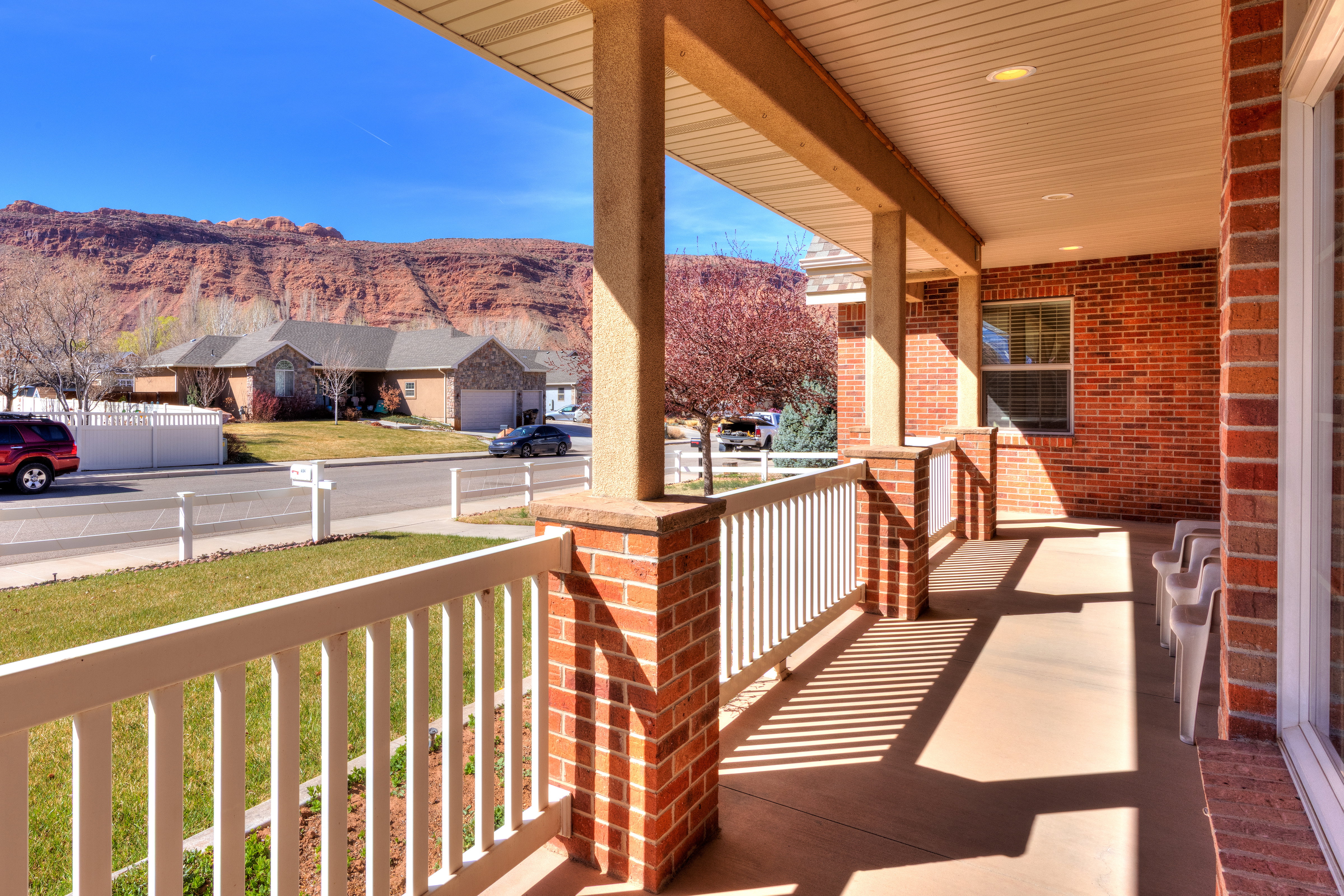 Exterior space featuring covered porch, a mountain view, and a residential view