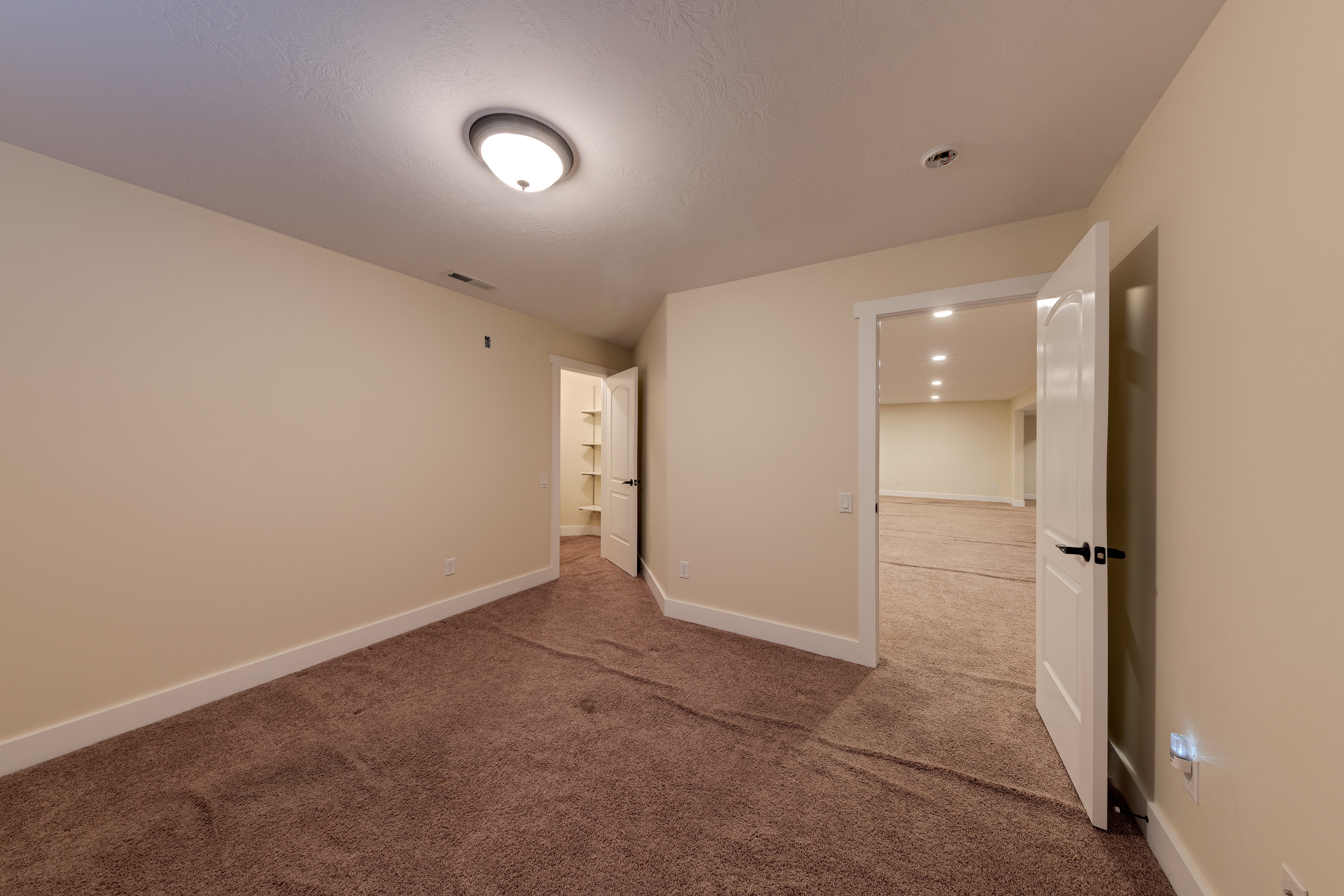 Unfurnished bedroom featuring baseboards, visible vents, and carpet