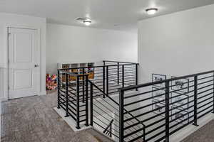 Interior space featuring visible vents and carpet floors
