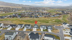 Bird's eye view featuring golf course view, a mountain view, and a residential view