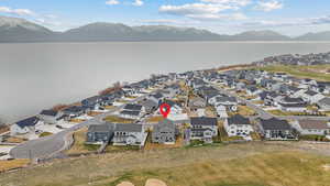 Birds eye view of property featuring a water and mountain view and a residential view