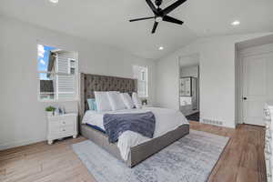 Bedroom featuring visible vents, baseboards, recessed lighting, lofted ceiling, and light wood-type flooring