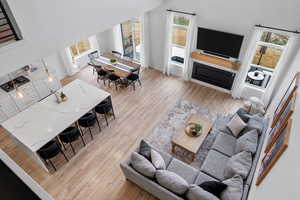 Living area with light wood-style flooring, baseboards, and a fireplace