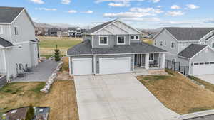 Traditional home featuring a front lawn, a residential view, driveway, and covered porch