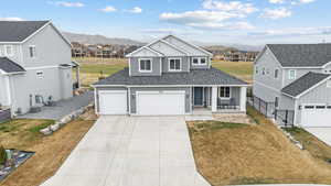 Traditional-style home with covered porch, a front yard, and a residential view