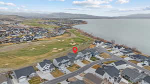 Aerial view featuring a residential view, golf course view, and a water and mountain view