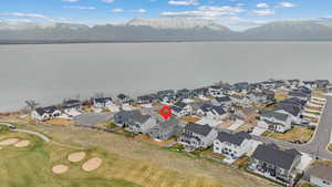 Birds eye view of property featuring a water and mountain view and a residential view