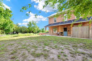 View of yard featuring fence and a patio area