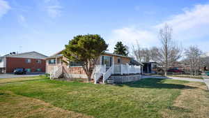 View of front of home featuring brick siding and a front yard