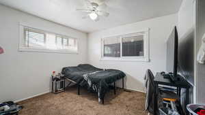 Carpeted bedroom with baseboards and ceiling fan