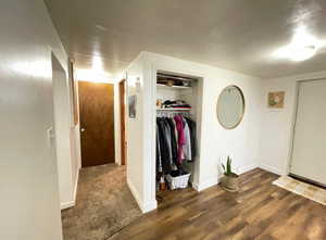 Hall with baseboards and wood finished floors