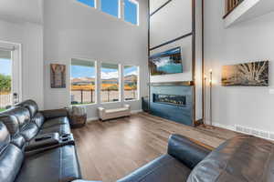 Living area with a wealth of natural light and a glass covered gas fireplace