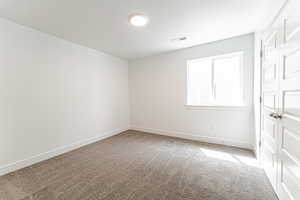Spare room featuring carpet