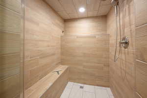 Bathroom with a shower stall and recessed lighting