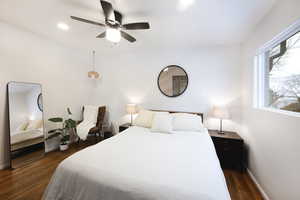 Bedroom with dark wood-style floors and a ceiling fan