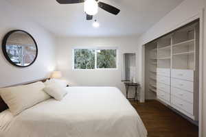Bedroom with dark wood-style flooring and ceiling fan