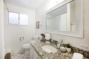 Bathroom with vanity, light tile patterned flooring, and shower / bath combo