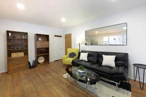 Living area with recessed lighting and wood-type flooring